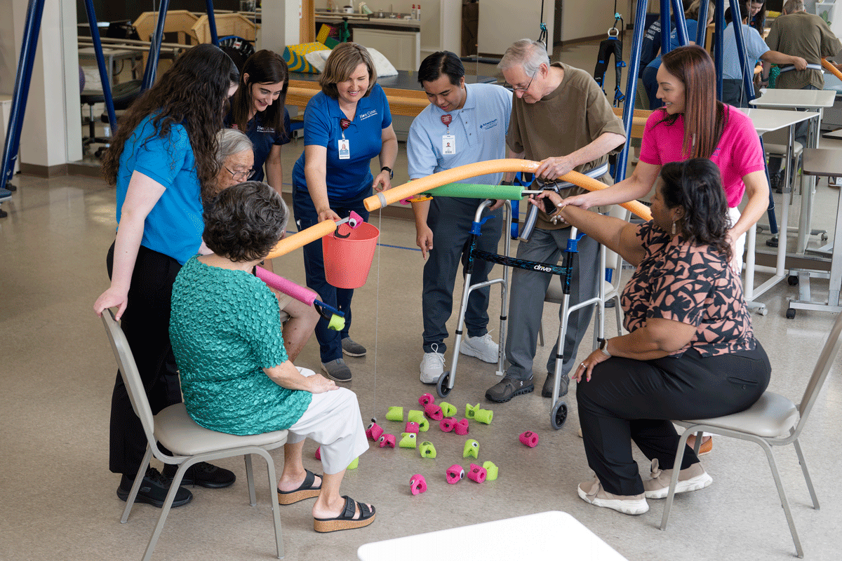 a group of people smiling and working together in the Hope Clinic.