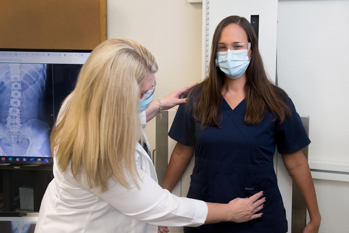 A faculty member and student demonstrate proper x-ray positioning