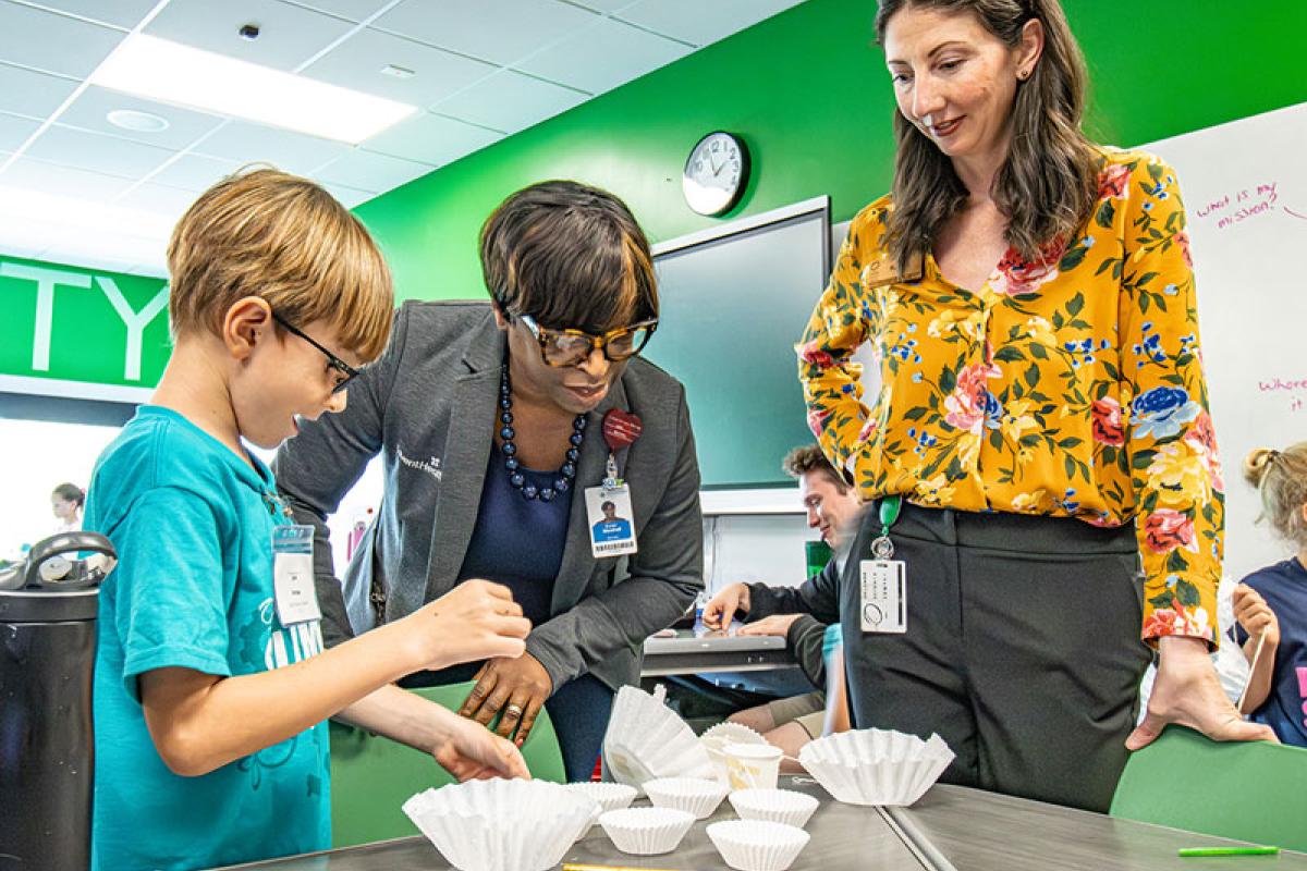 AHU Provost, Karen Benn Marshall observes little boy conducting experiment