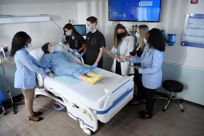 A group of students learning through a hospital floor simulation