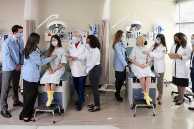 Groups of students practicing skills in the physician assistant lab