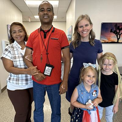 Glexey Caraballo stands with his mother, and Cathy Garrett stands with her daughters. Both Glexey and Cathy performed in STROKESTRA as part of their recovery.