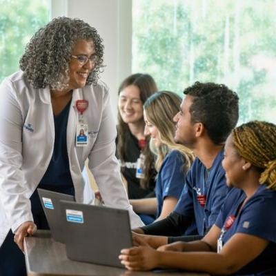 nursing students smiling at teacher in classroom