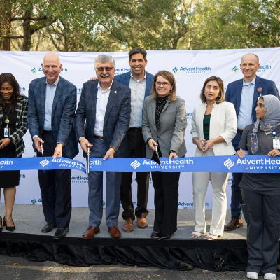 Leaders from AdventHealth and AHU cutting the ribbon at AHU Tampa