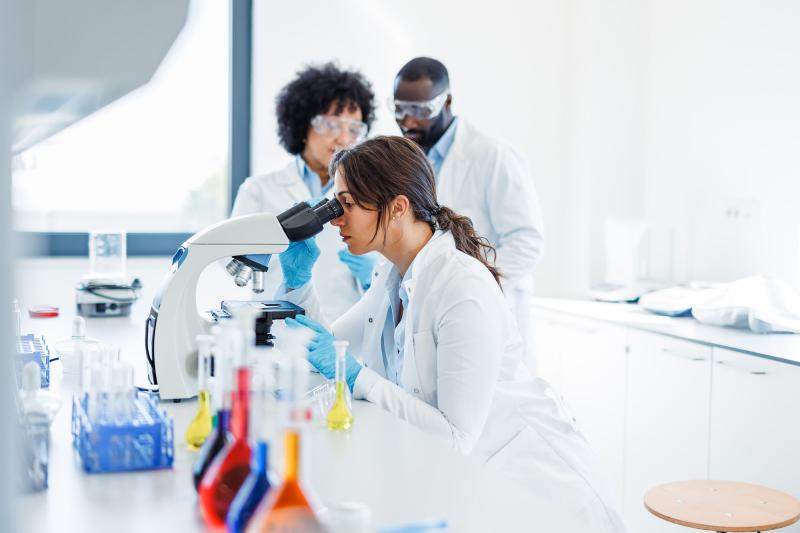 A biomedical scientist uses a microscope
