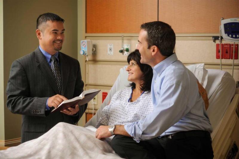 Chaplain with patient and family