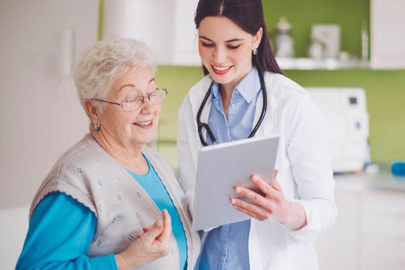 A nurse practitioner reviews a chart with a patient