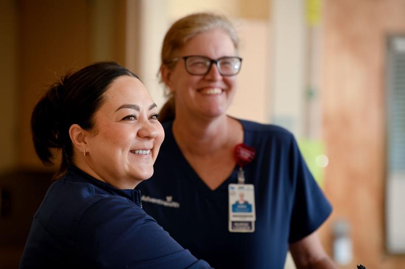 Two older female nurses in a hospital floor