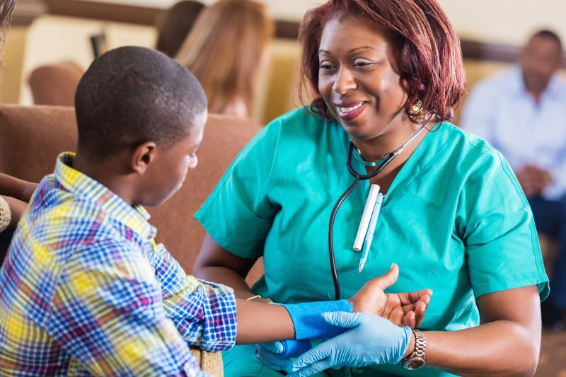 nurse examining boy