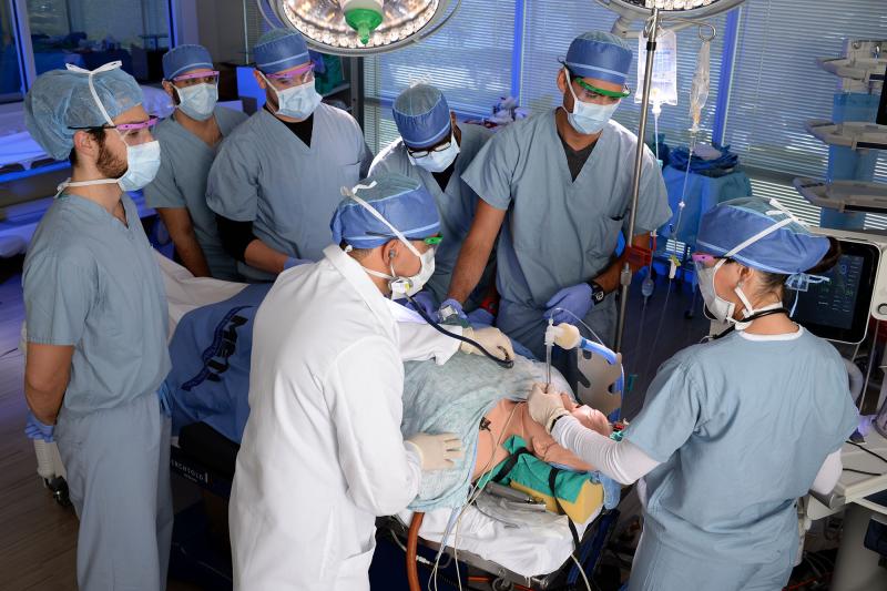 A group of nurse anesthesia students running a simulation in the operating room with faculty supervision