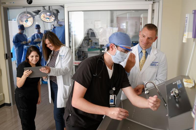 A physician assistant student scrubs in during a surgical simulation