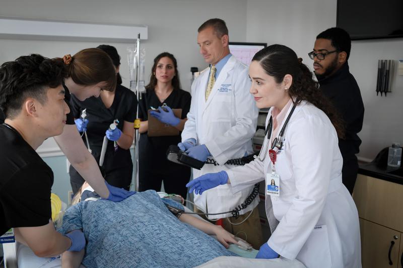 Physician assistant faculty members supervise a hospital simulation for students