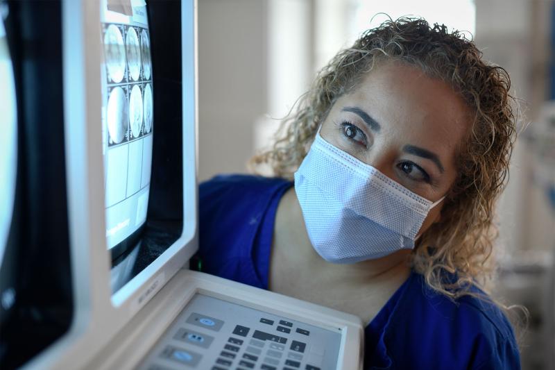 A female radiography student viewing a diagnostic image on a monitor