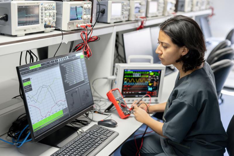 A healthcare technology worker reading a computer screen