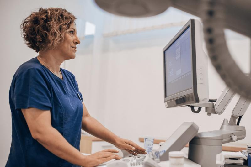 A healthcare worker looking at a computer display