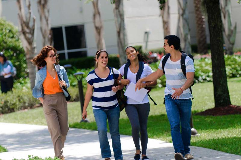 A group of students walking outside on AHU's campus