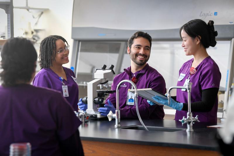 three students smiling in the lab