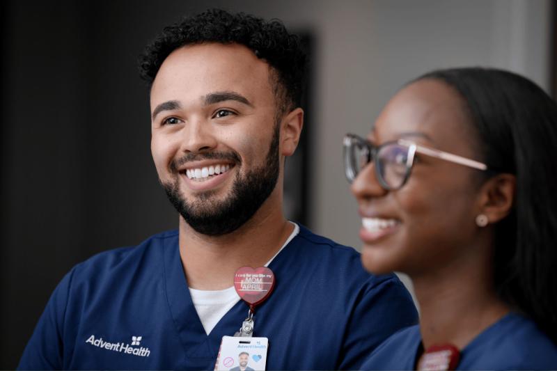 A young male nurse standing with a young female nurse