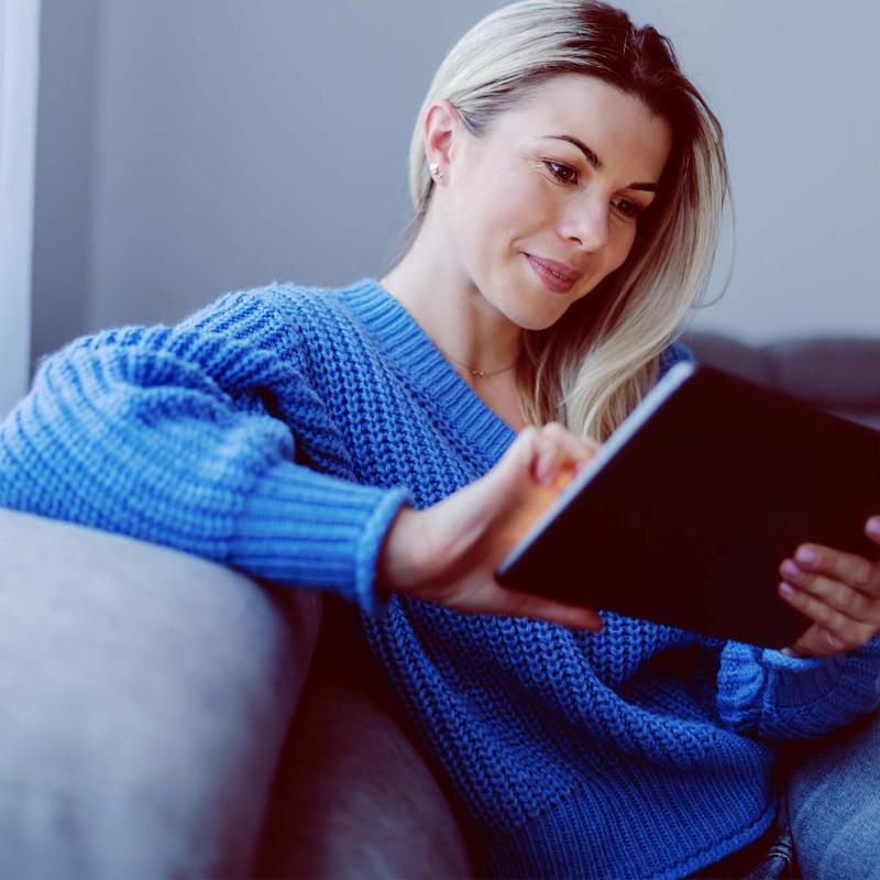 Young woman using a tablet on the couch