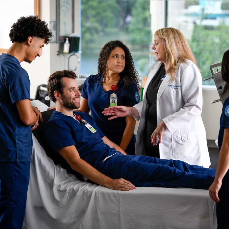 Professor and students in radiography lab