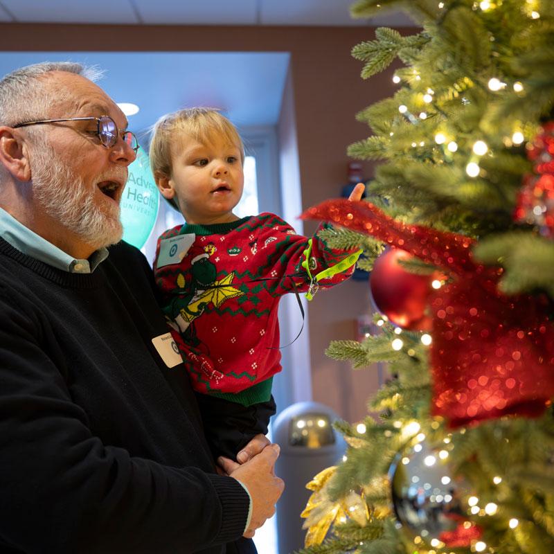 little-boy-with-grandfather-looking-at-Christmas-tree