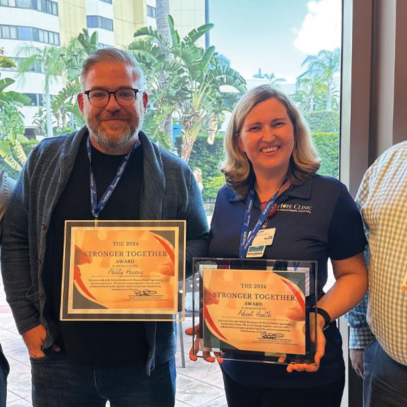 A group from Florida Coalition to End Homelessness pose with an award