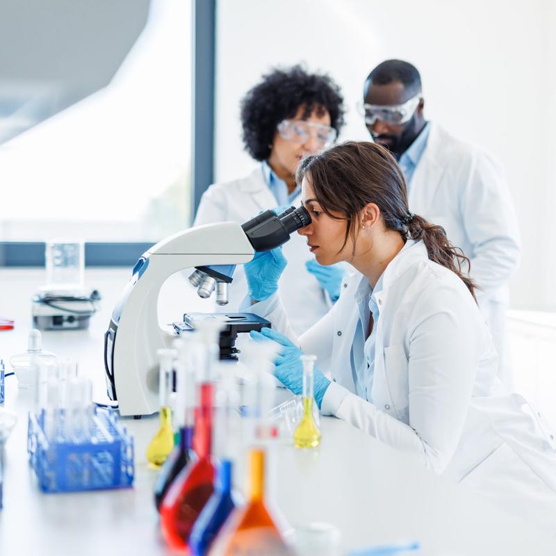 A biomedical scientist uses a microscope