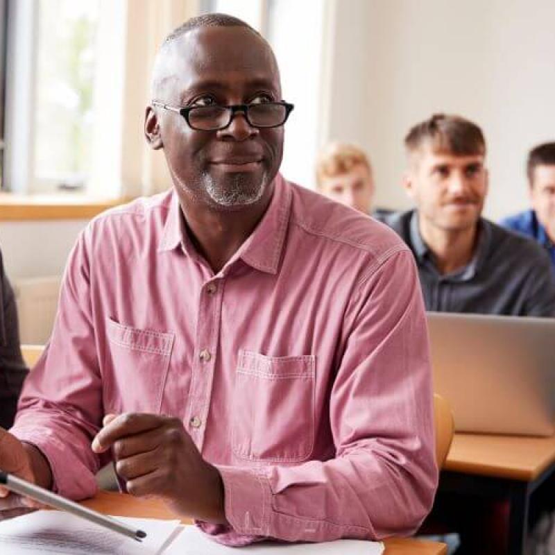 Older Black man in classroom