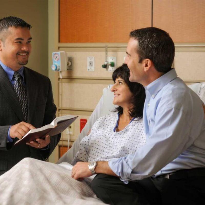 Chaplain with patient and family