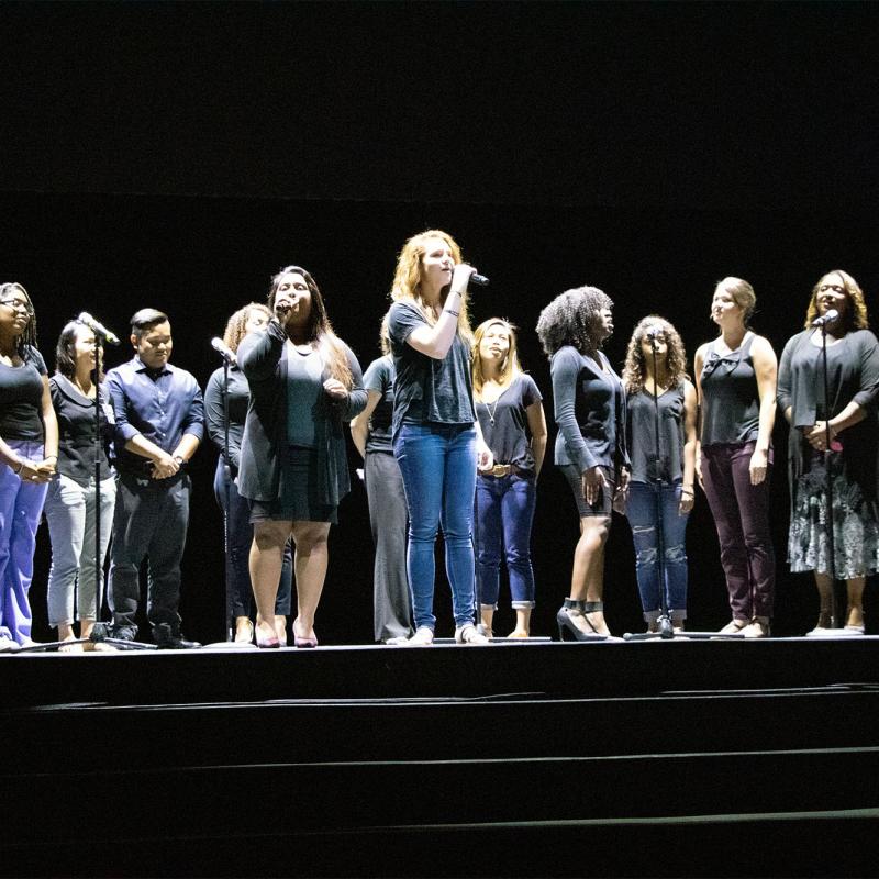 Students singing on stage during Convocation