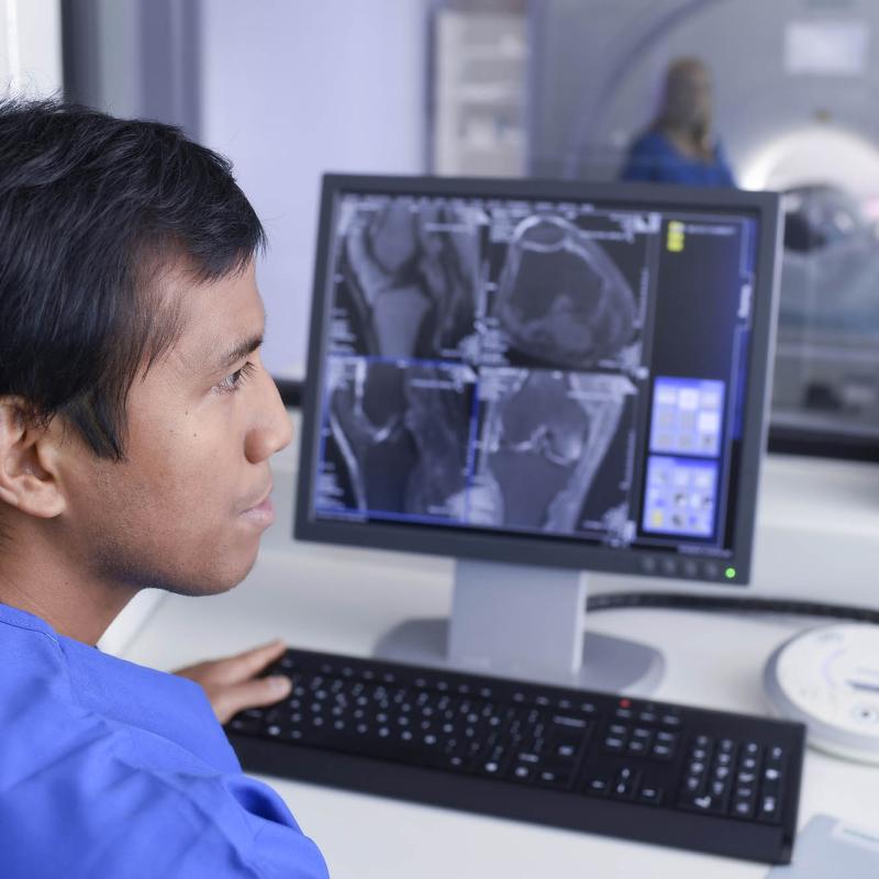 MRI Technician using a computer