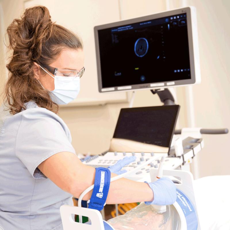 Female sonography student practicing scanning