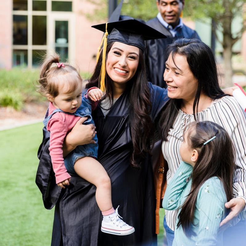 A graduate her family group hugging