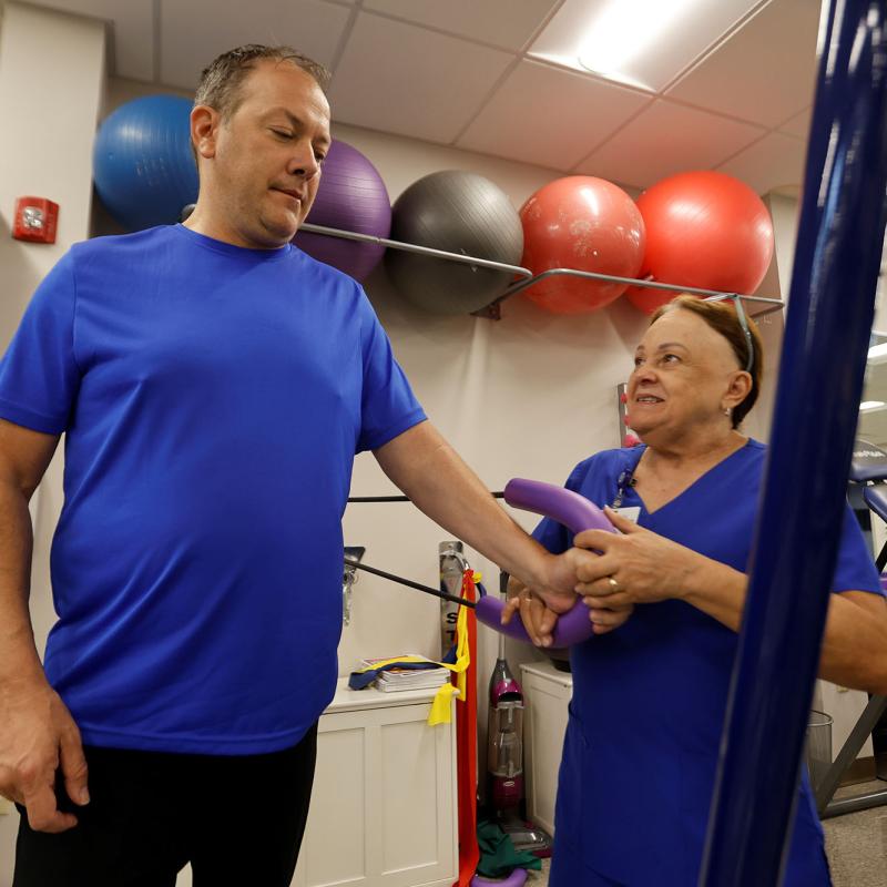 A patient works with an occupational therapist at AHU's Hope Clinic