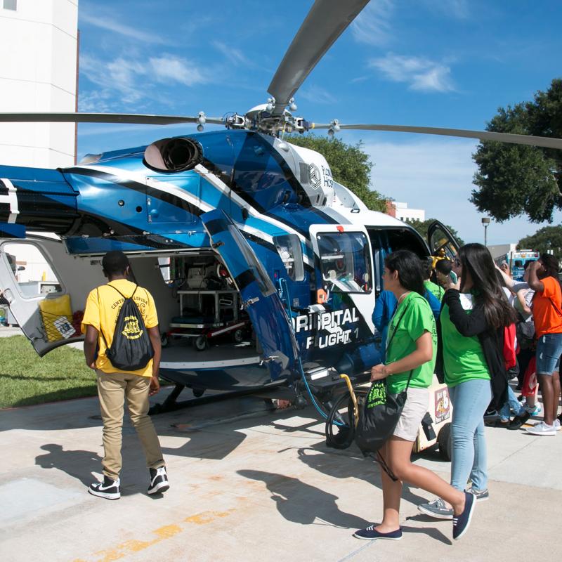 A group of visiting students viewing the hospital helicopter