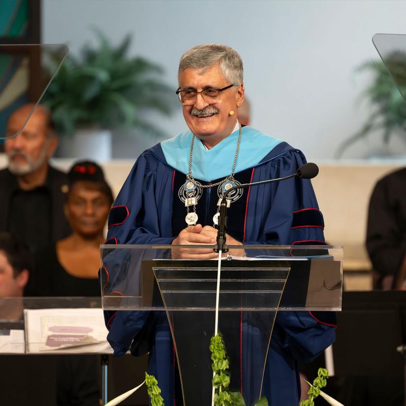 Josef Ghosn in regalia speaking at the lectern during the inauguration ceremony