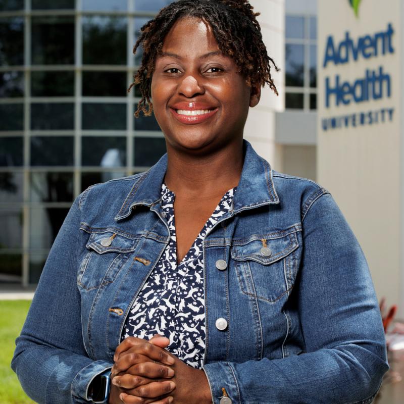 Khandi Stewart-Cooper standing outside the Campus Center building at AHU