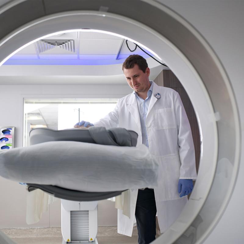 A male nuclear medicine student conducting a PET scan