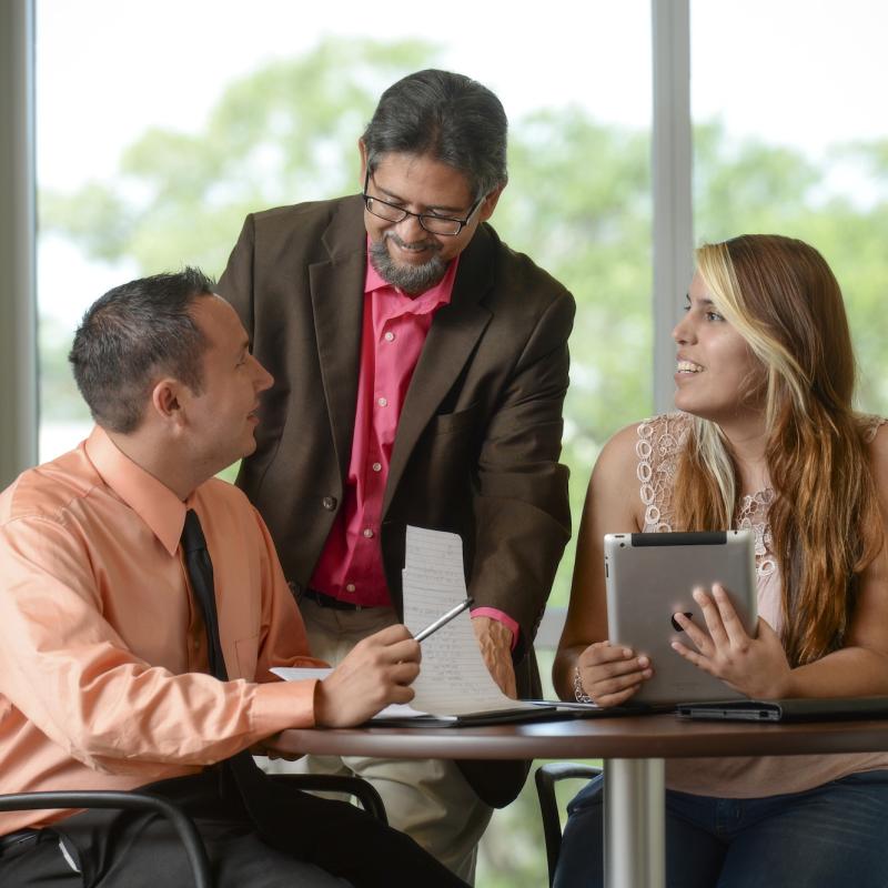 Two students and professor talking