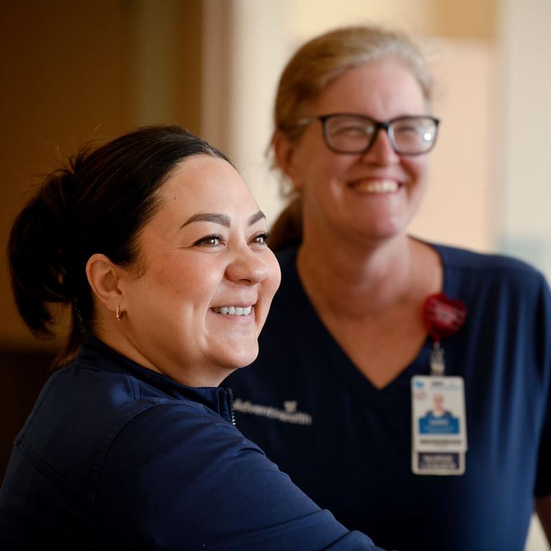 Two older female nurses in a hospital floor