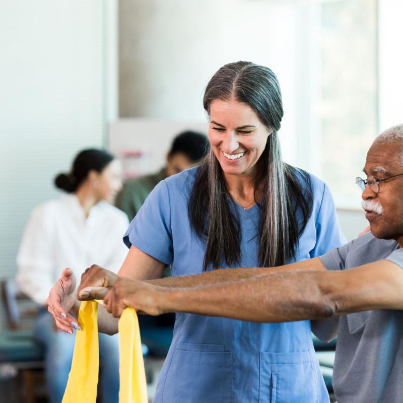 An occupational therapist works with a patient