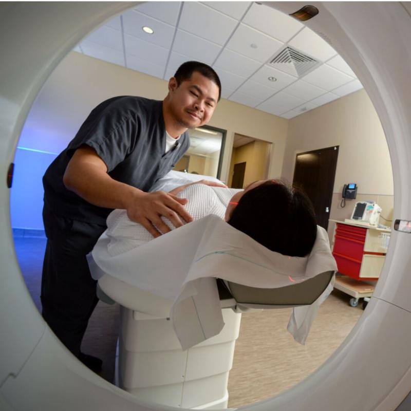 An imaging tech scans a patient