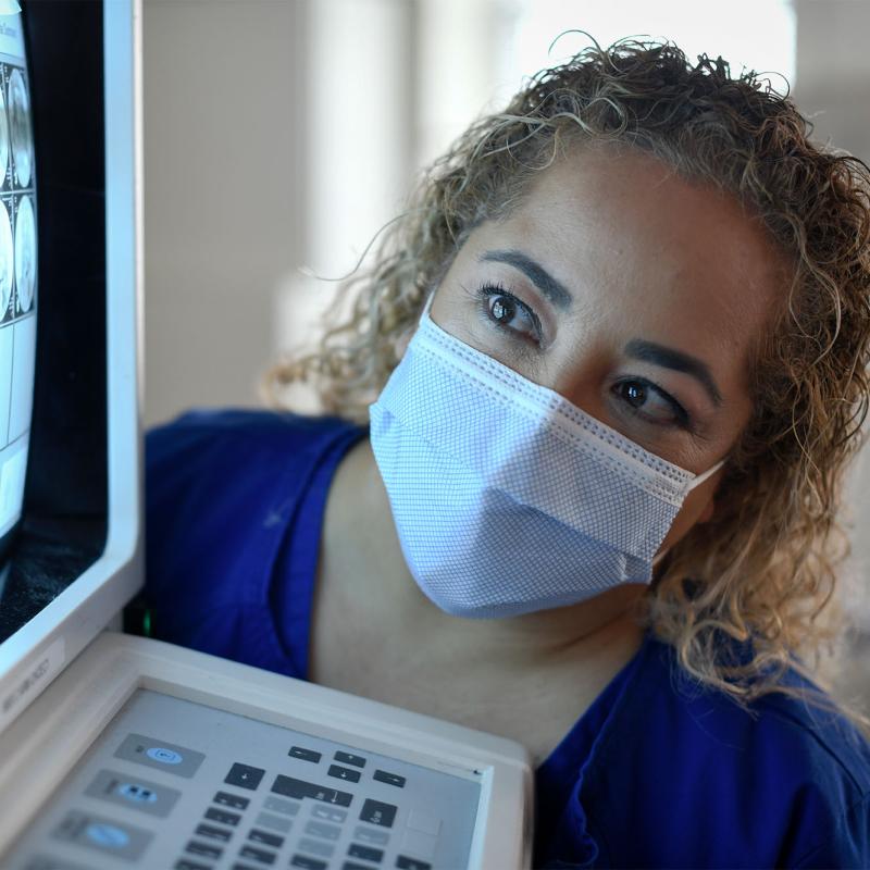 A female radiography student viewing a diagnostic image on a monitor