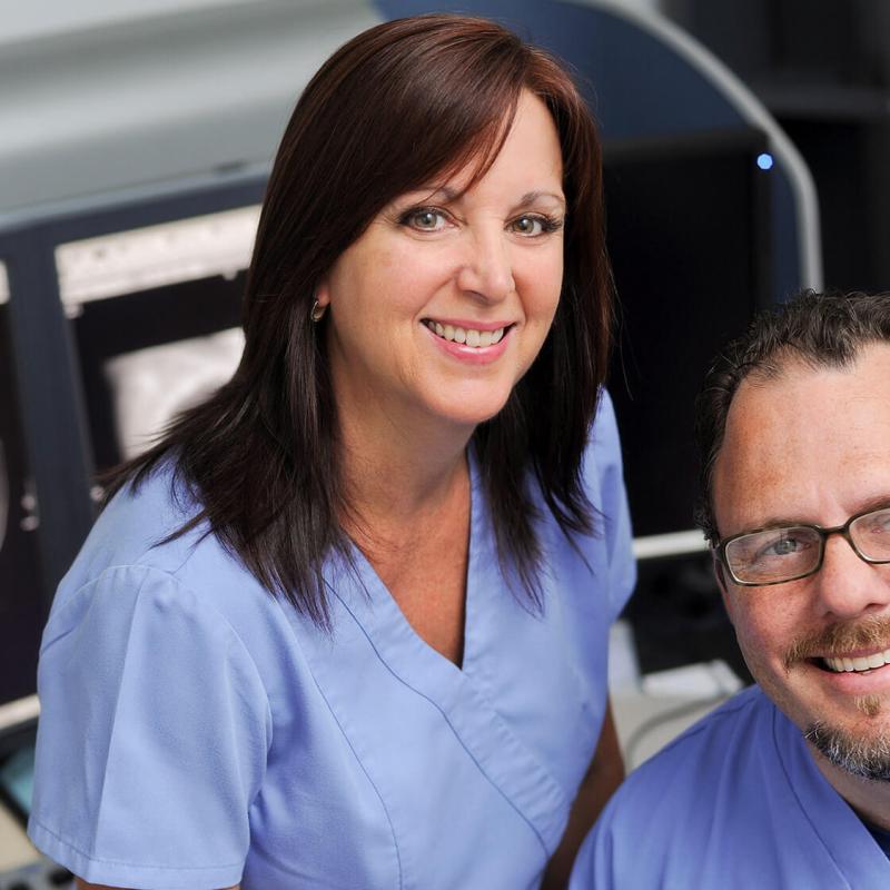 Man And Woman In front of CT Screen