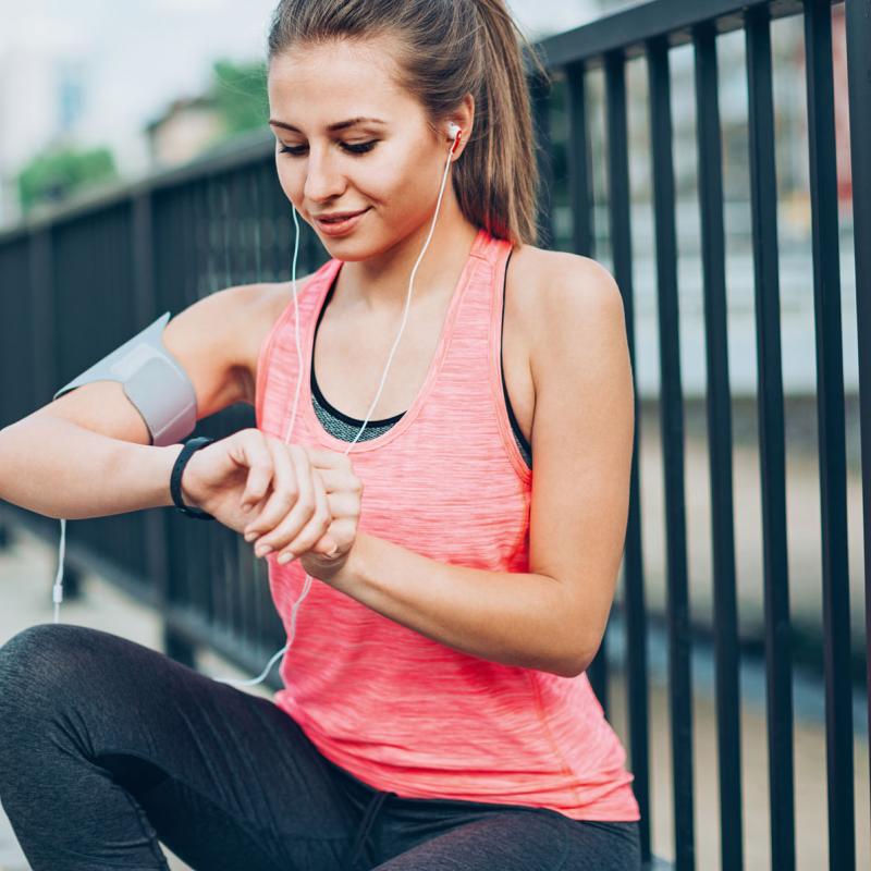 A runner checking her time