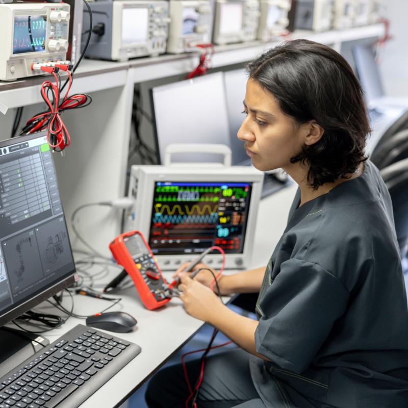 A healthcare technology worker reading a computer screen