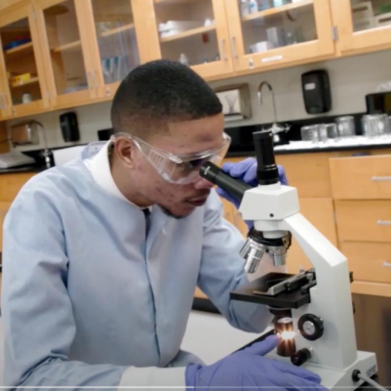 Sean Chin Chan using a microscope