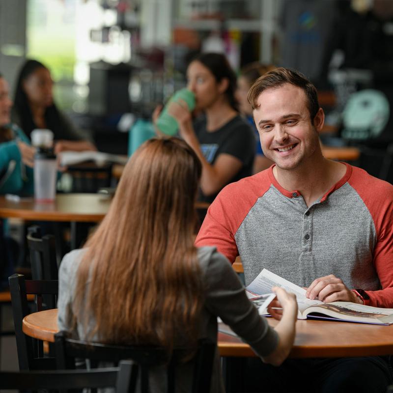 Students conversing in the university cafeteria