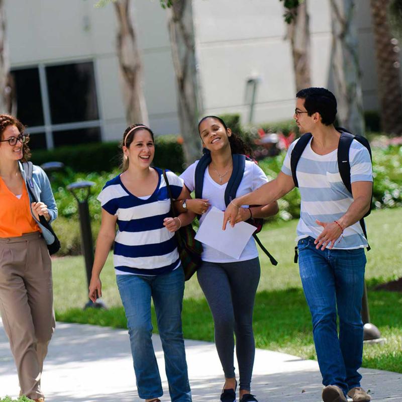 A group of students walks outside on campus
