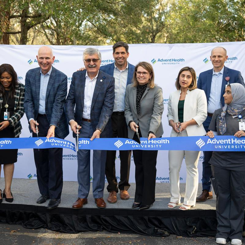 Leaders from AdventHealth and AHU cutting the ribbon at AHU Tampa